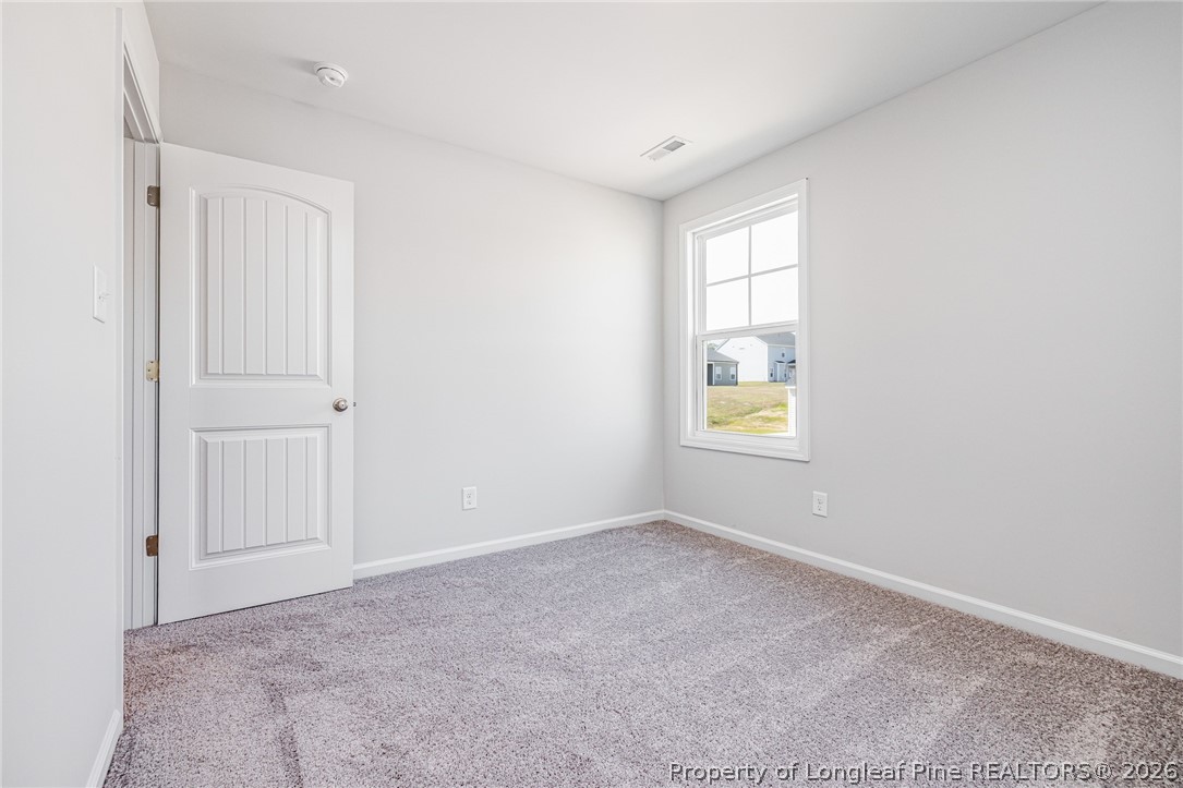 5413 Short Leaf Road Fayetteville, NC 28311 - Photo 14 of 33 a view of an empty room with a window