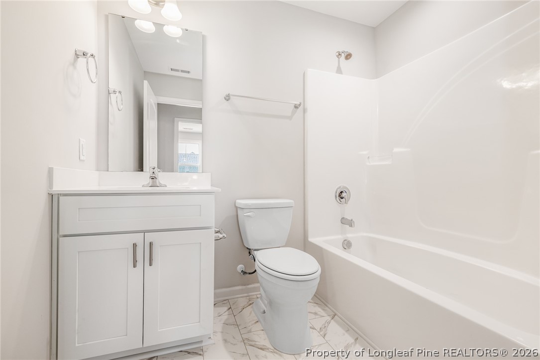 5413 Short Leaf Road Fayetteville, NC 28311 - Photo 18 of 33 a bathroom with a sink a toilet and a bathtub