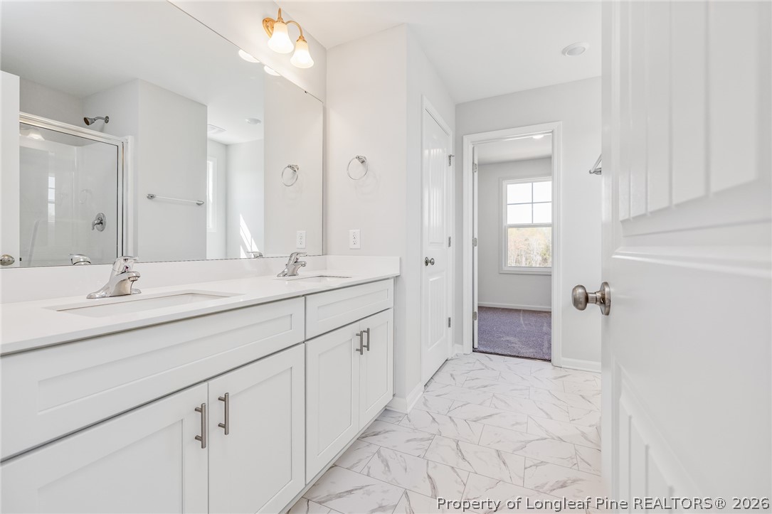 5413 Short Leaf Road Fayetteville, NC 28311 - Photo 23 of 33 a spacious bathroom with a double vanity sink mirror and double