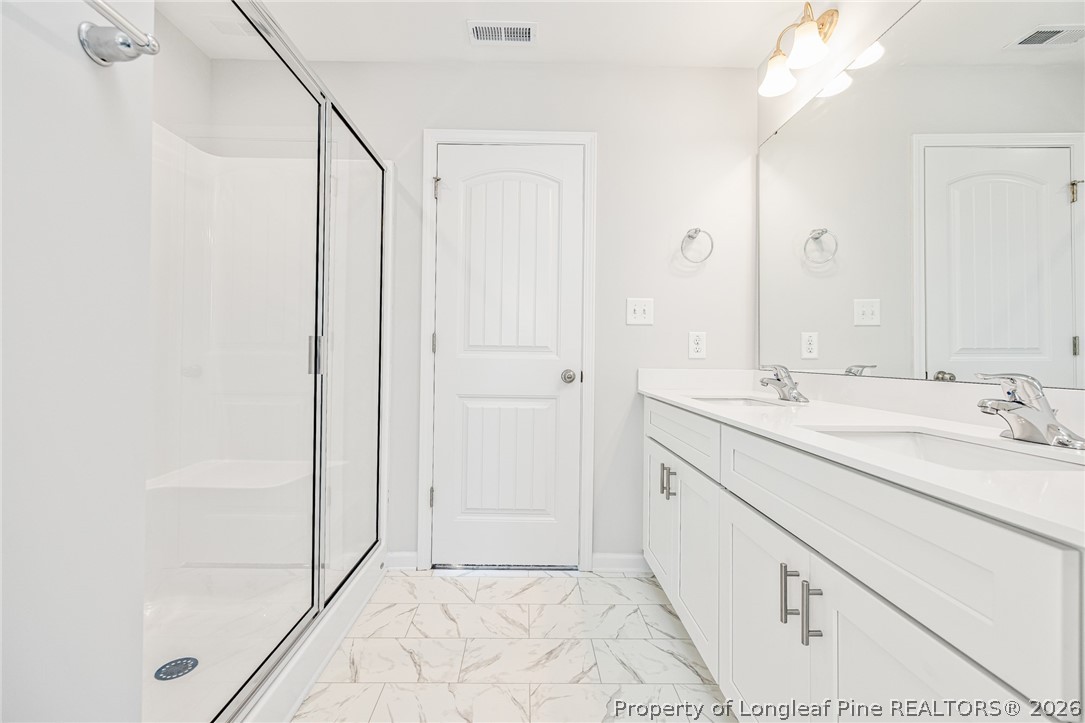 5413 Short Leaf Road Fayetteville, NC 28311 - Photo 24 of 33 a bathroom with a sink and a mirror