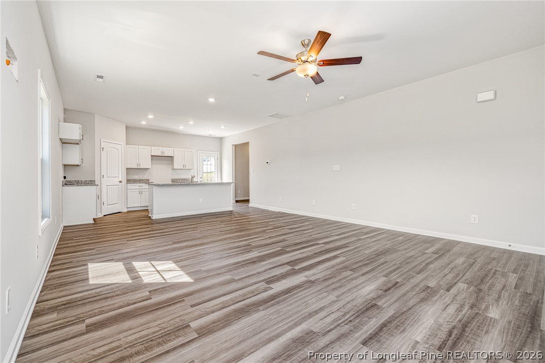 5413 Short Leaf Road Fayetteville, NC 28311 - Photo 3 of 33 a view of kitchen and empty room with wooden floor