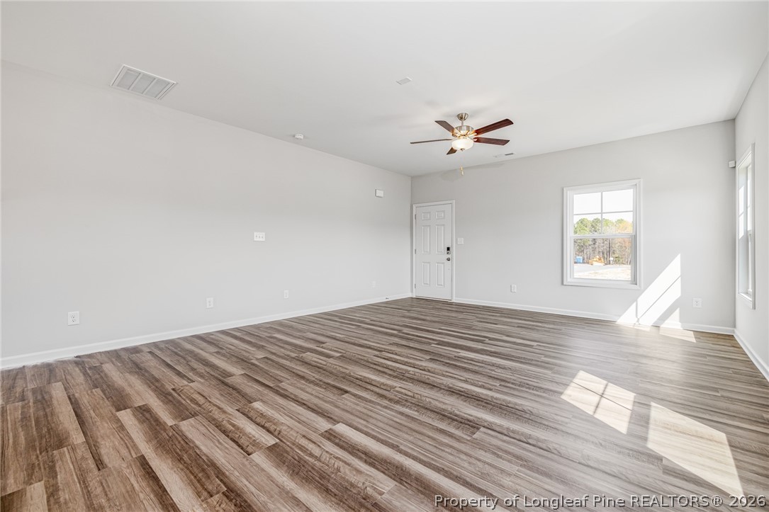 5413 Short Leaf Road Fayetteville, NC 28311 - Photo 5 of 33 a view of a bedroom with wooden floor and ceiling fan