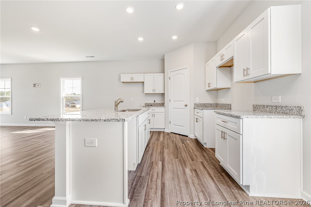 5413 Short Leaf Road Fayetteville, NC 28311 - Photo 7 of 33 a kitchen with white cabinets appliances and a sink