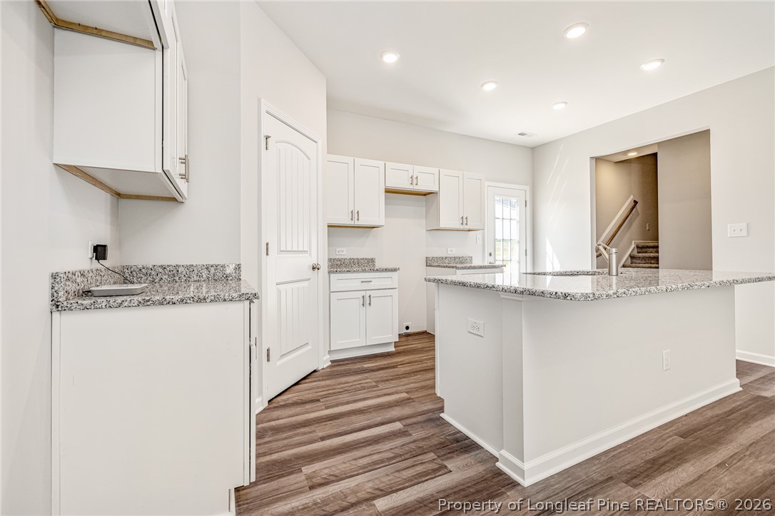5413 Short Leaf Road Fayetteville, NC 28311 - Photo 8 of 33 a kitchen with kitchen island a sink stainless steel appliances and cabinets