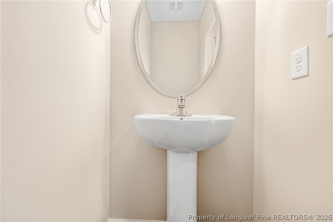 5413 Short Leaf Road Fayetteville, NC 28311 - Photo 10 of 33 a room with a sink and a mirror