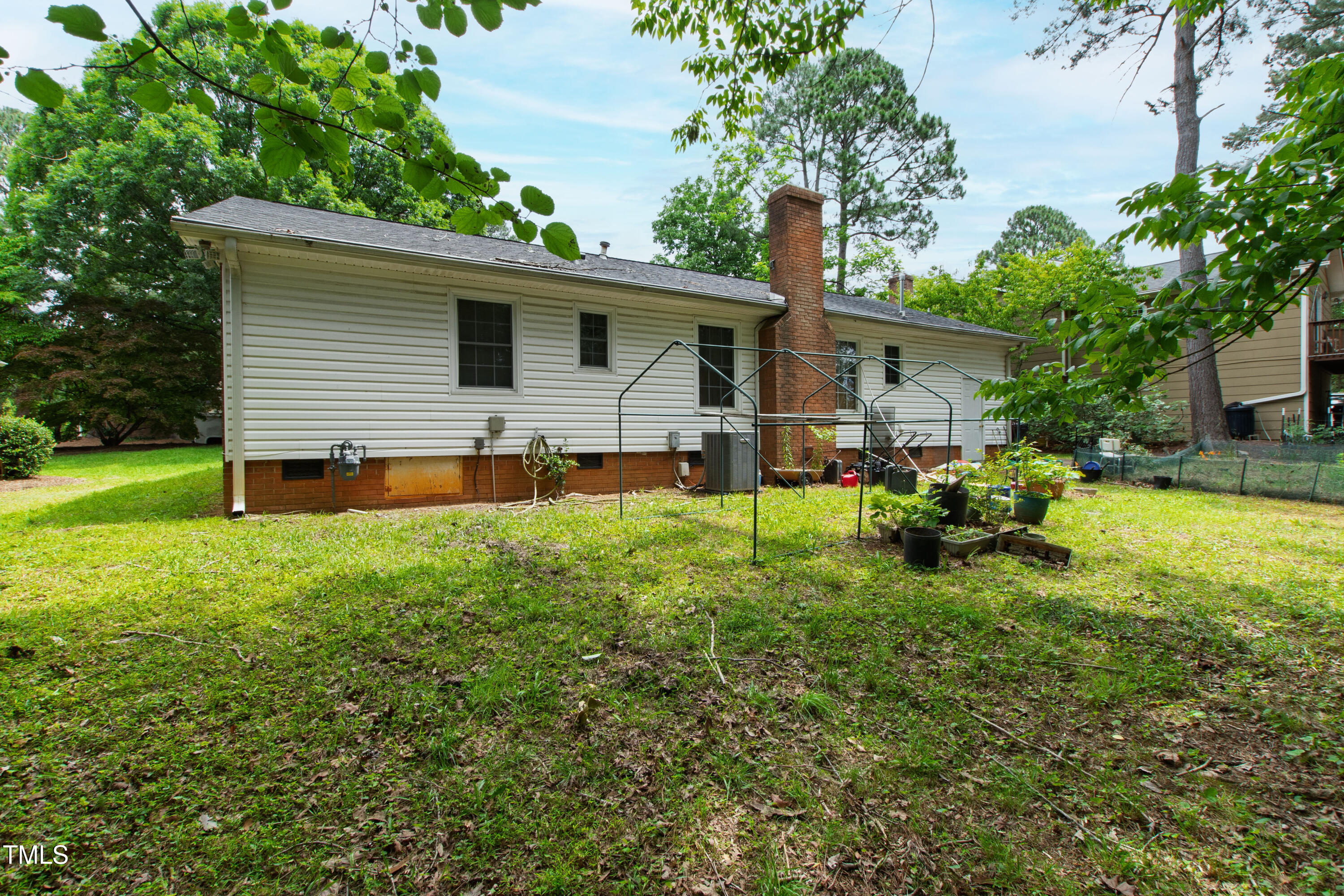 3517 Morningside Drive Raleigh, NC 27607 - Photo 6 of 9 a backyard of a house with table and chairs plants and large tree