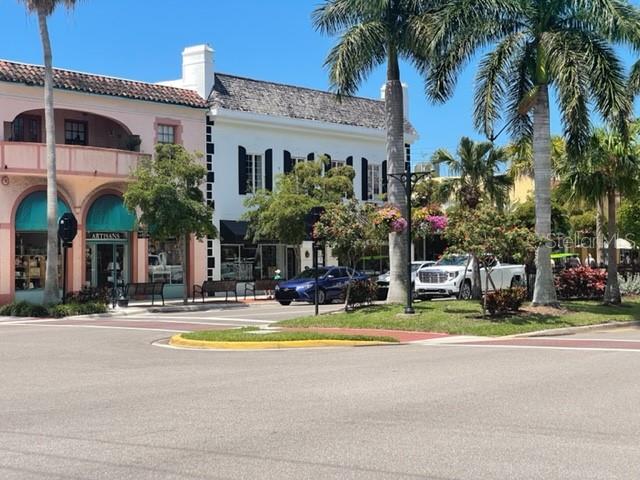 20080 Ragazza Circle, Unit 102 Venice, FL 34293 - Photo 48 of 49 a view of a building with a patio and a yard