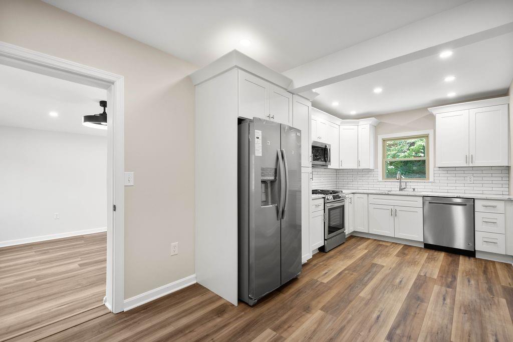 175 McMurray Road Pittsburgh, PA 15241 - Photo 11 of 45 a kitchen with a refrigerator a stove top oven and wooden floor