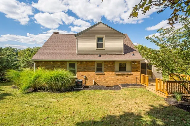 a front view of house with yard and trees around