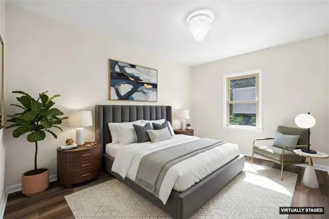 a bedroom with a bed and a potted plant