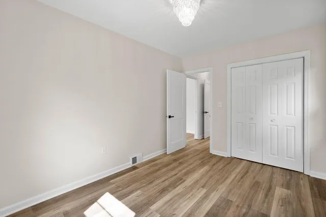 a view of a room with wooden floor