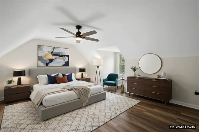 a bedroom with a bed large window and a chandelier