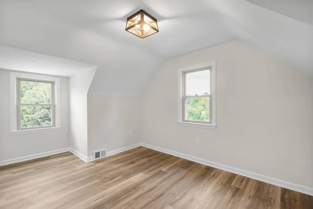 an empty room with windows and closet