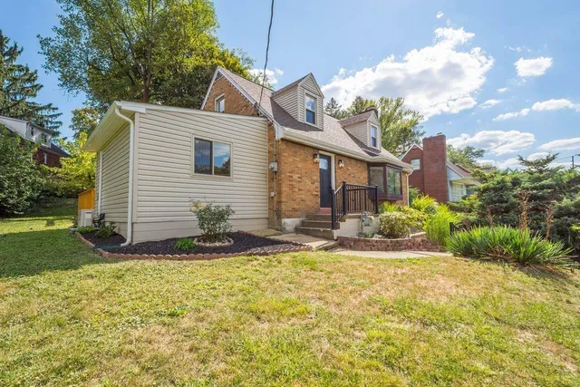a front view of a house with a yard