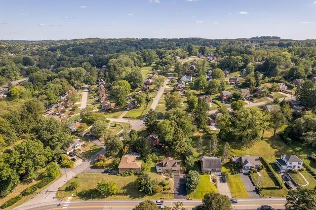 an aerial view of residential houses with city view