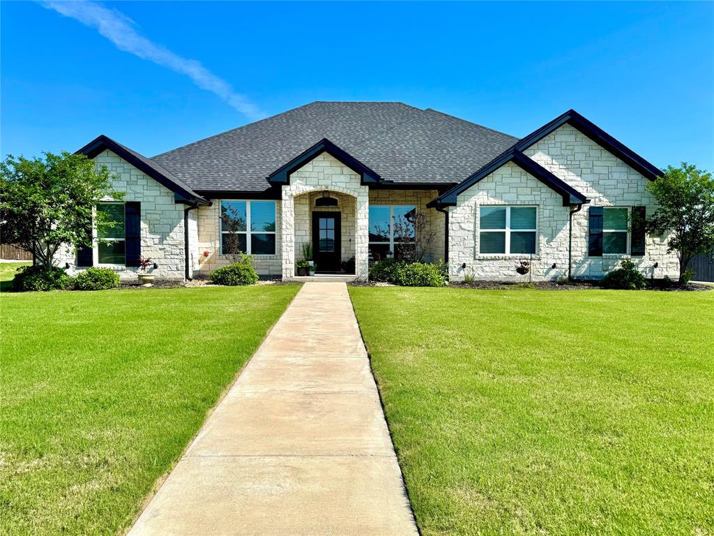 297 Aerl Road Lorena, TX 76655 - Photo 1 of 1 View of front of home with a shingled roof, a front lawn, and stone siding