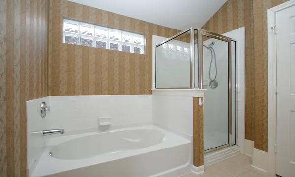 a bathroom with a bathtub and a shower