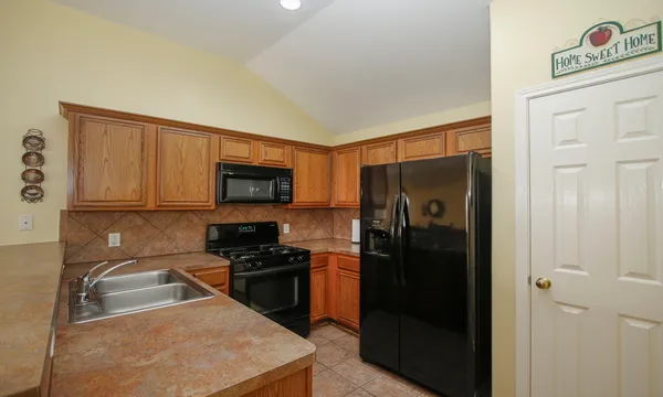 a kitchen with a refrigerator stove and sink