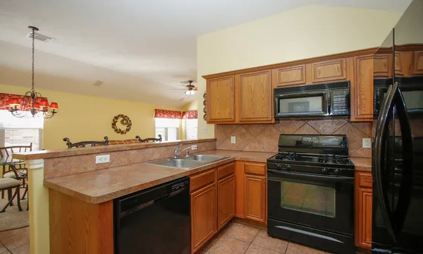a kitchen with a sink stove and microwave