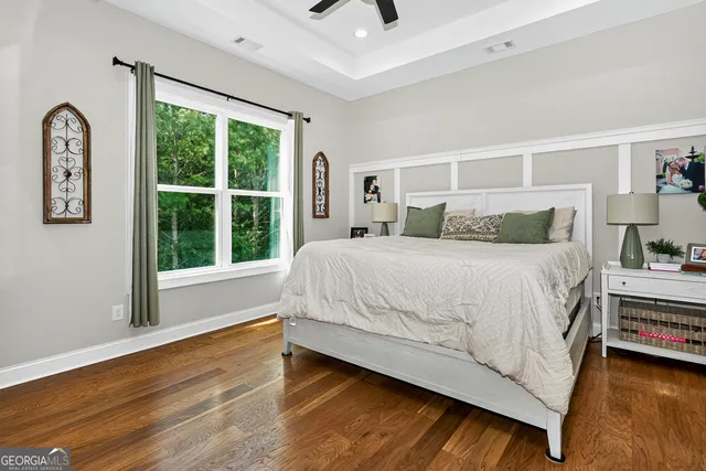 a bedroom with a large bed and a large window