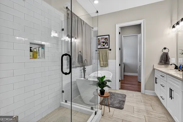 a en suite bathroom with a granite countertop sink and a mirror