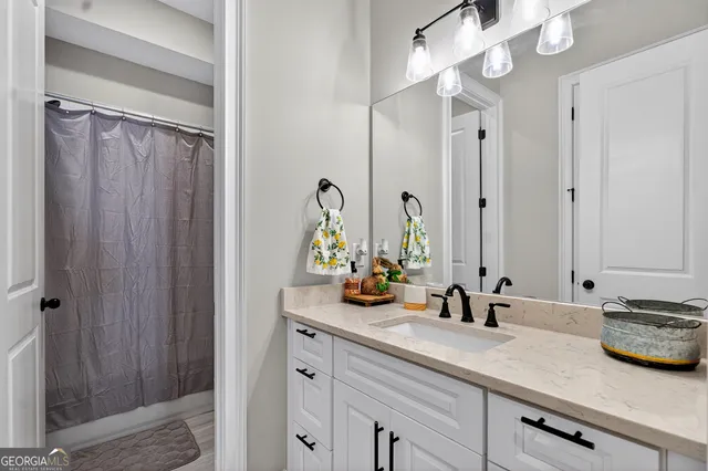 a bathroom with a double vanity sink and a mirror