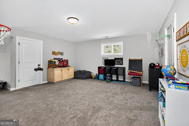 a living room with furniture and a gym equipment
