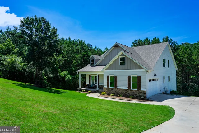 a front view of house with yard and green space