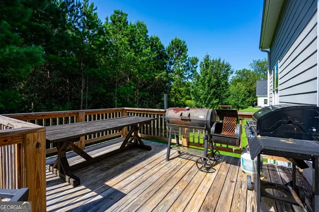 a view of a roof deck with wooden floor and fence
