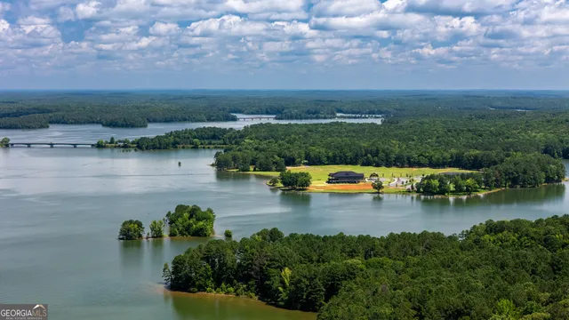 an aerial view of a house with swimming pool garden and patio