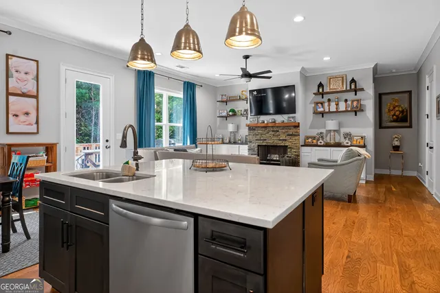 a open kitchen with stainless steel appliances granite countertop a sink a stove and a refrigerator