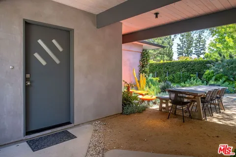 a view of a backyard with plants and a garden
