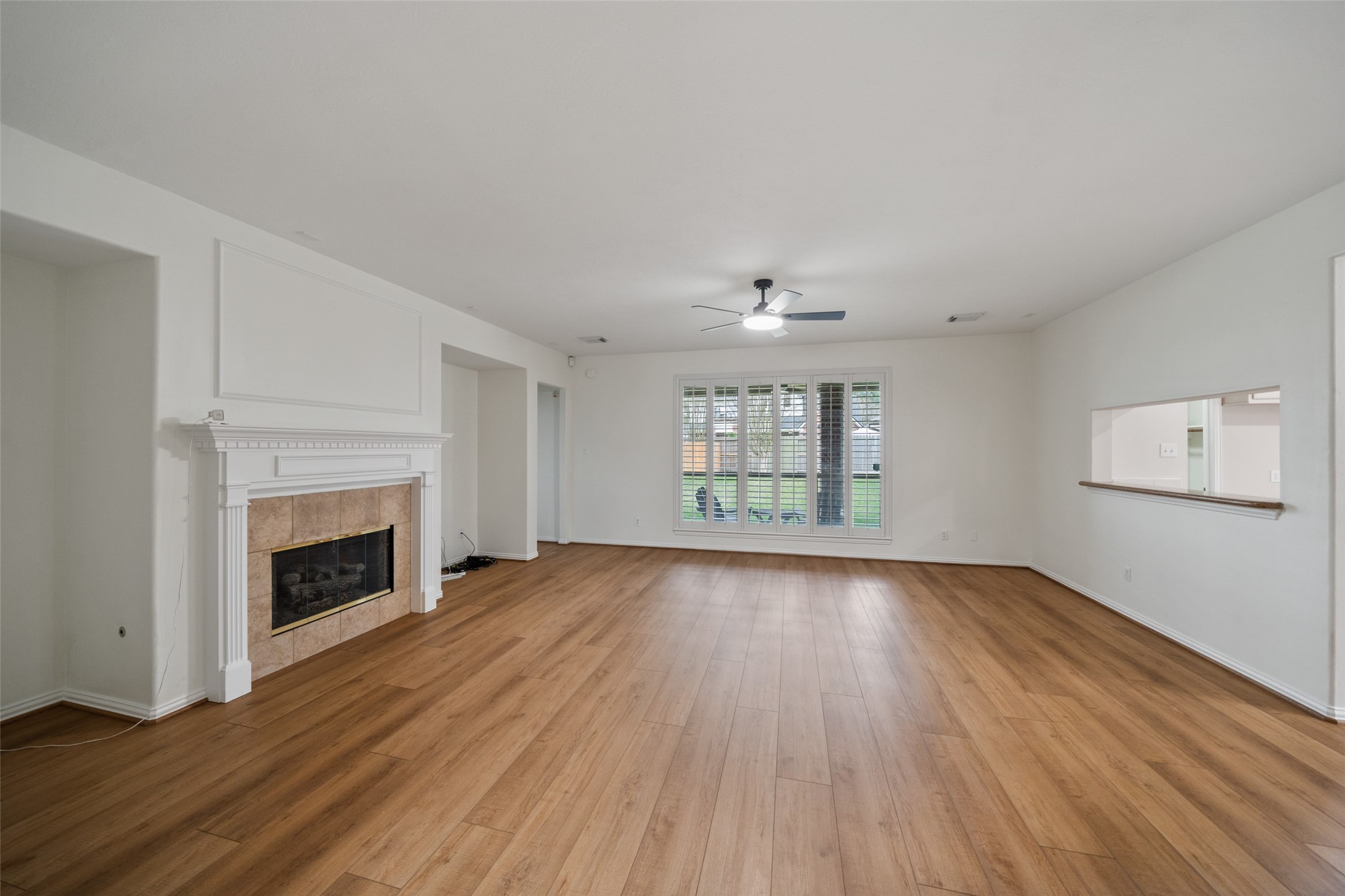 14803 Ramblebrook Humble, TX 77396 - Photo 17 of 45 wooden floor fireplace and windows in an empty room