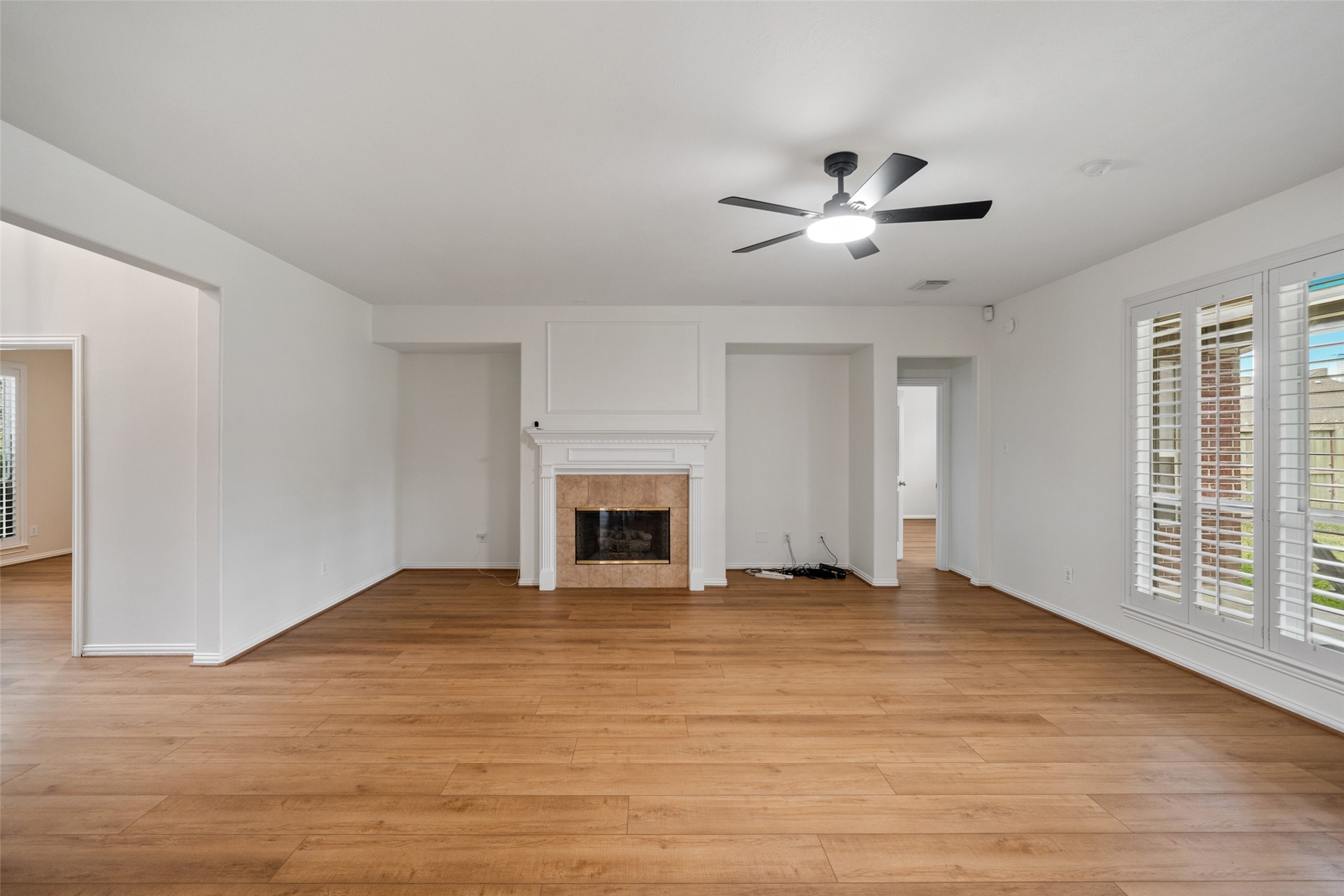 14803 Ramblebrook Humble, TX 77396 - Photo 18 of 45 a view of empty room with wooden floor and fireplace