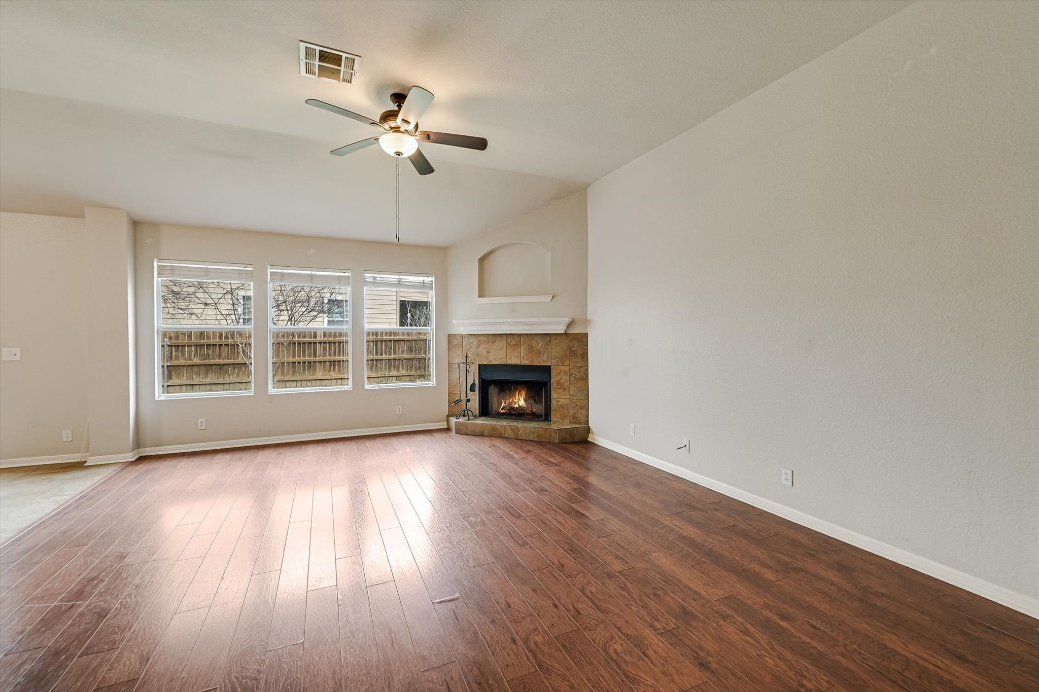 9616 Magna Carta Loop Austin, TX 78754 - Photo 11 of 28 a view of a room with wooden floor fireplace and windows