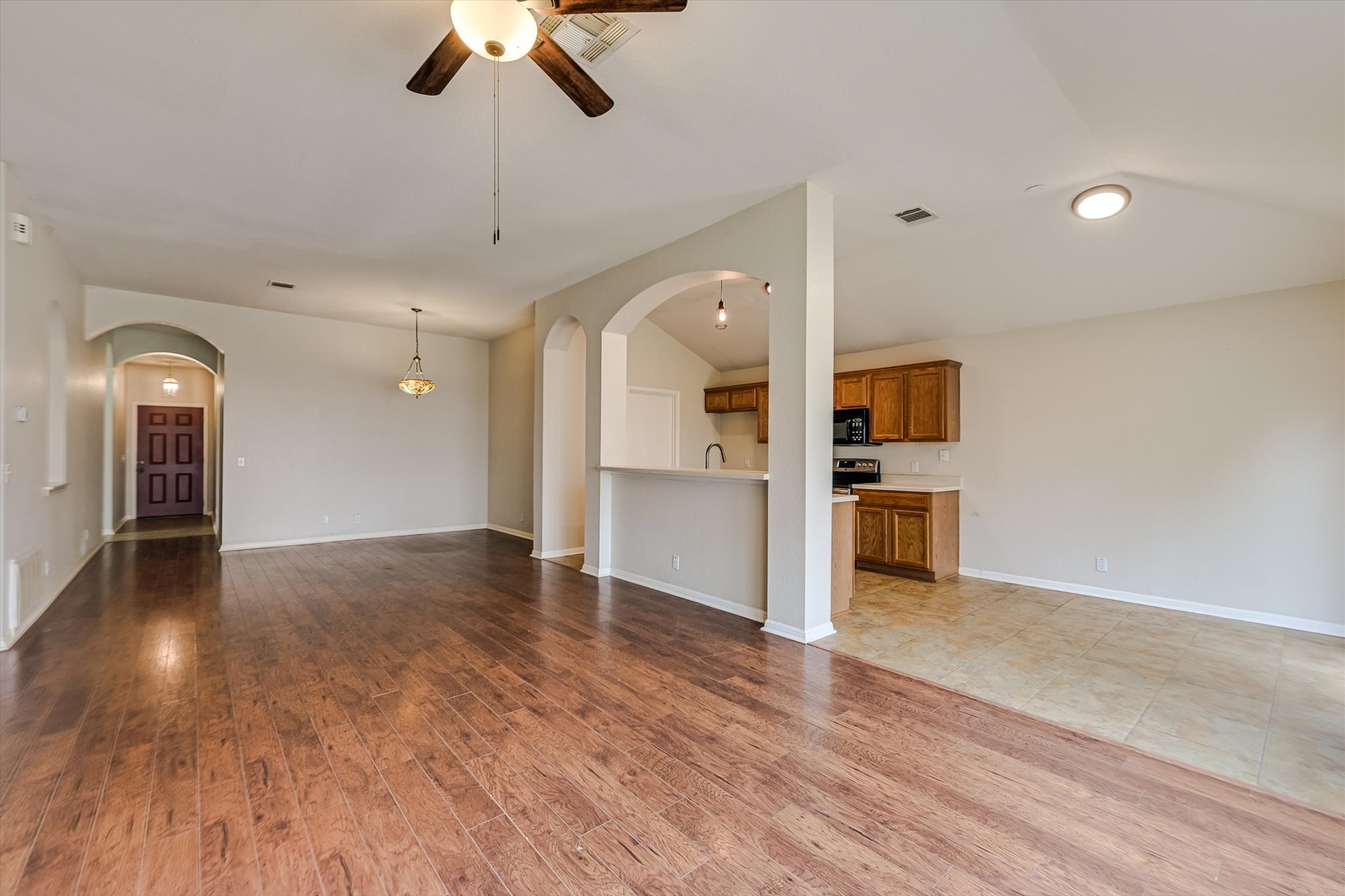 9616 Magna Carta Loop Austin, TX 78754 - Photo 14 of 28 a view of a kitchen with a dishwasher cabinets and wooden floor