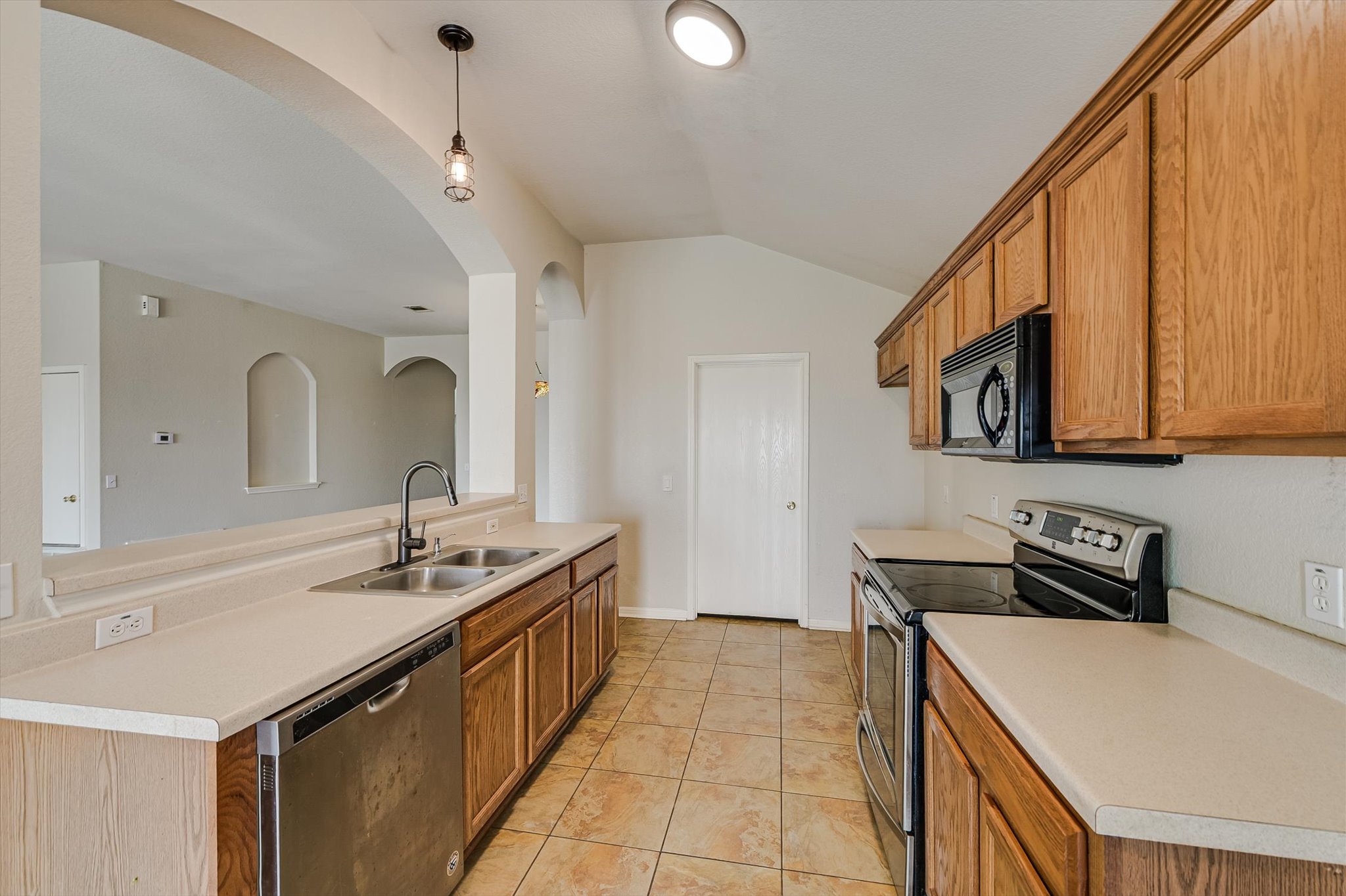 9616 Magna Carta Loop Austin, TX 78754 - Photo 16 of 28 a kitchen with a sink stove and microwave
