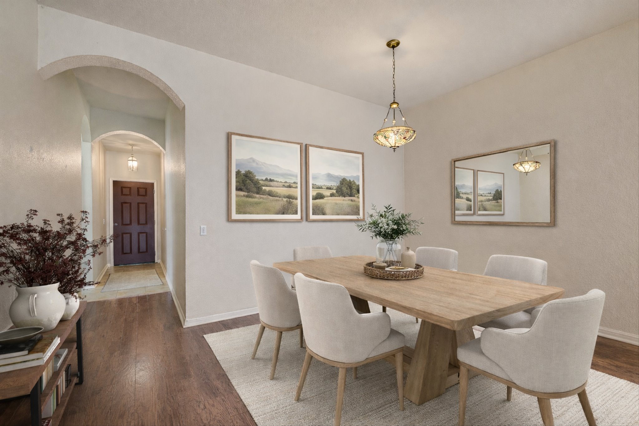 9616 Magna Carta Loop Austin, TX 78754 - Photo 3 of 28 a dining room with furniture a chandelier and wooden floor