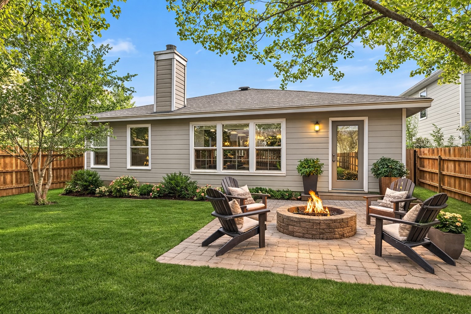 9616 Magna Carta Loop Austin, TX 78754 - Photo 8 of 28 a view of a backyard with table and chairs potted plants and a large tree