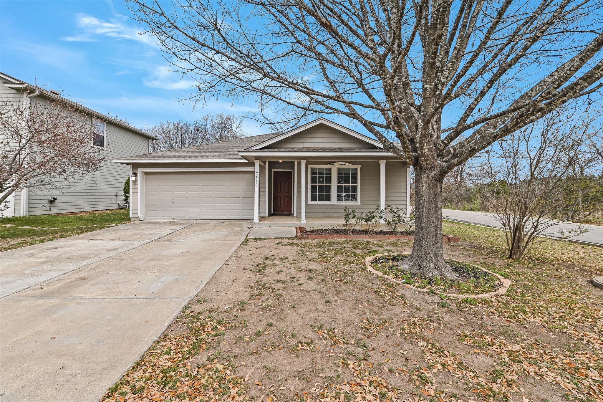 9616 Magna Carta Loop Austin, TX 78754 - Photo 10 of 28 a front view of a house with a yard and garage