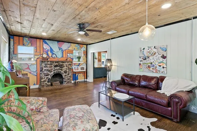 a living room with furniture a fireplace and a flat screen tv