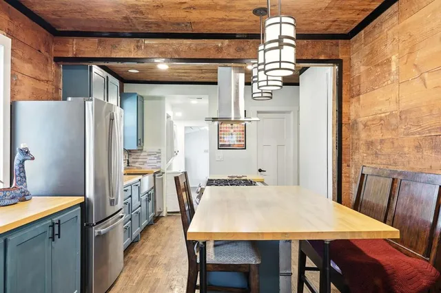 a dining table with chairs and window