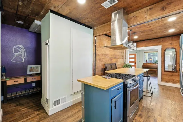 a kitchen with stainless steel appliances granite countertop a stove a sink and a refrigerator