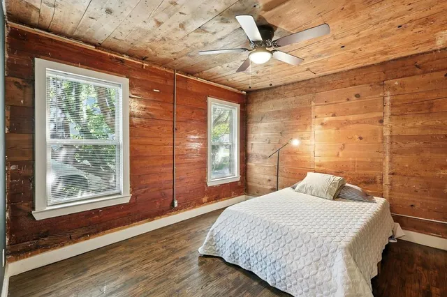 a bedroom with a large bed and a window