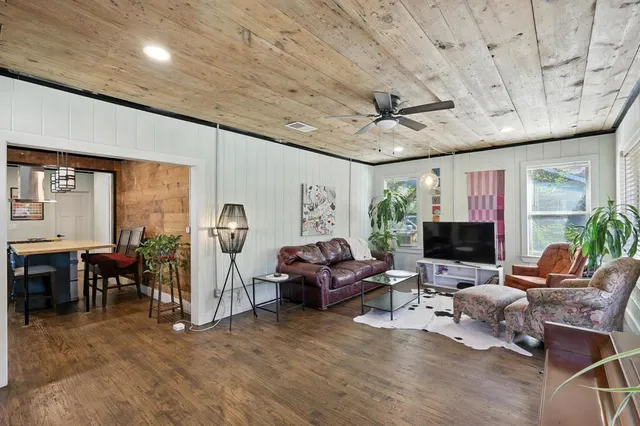 a living room with furniture a fireplace and a table