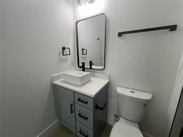 a bathroom with a sink toilet and vanity