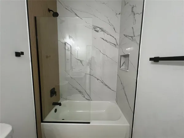 a bathroom with a tub and a shower