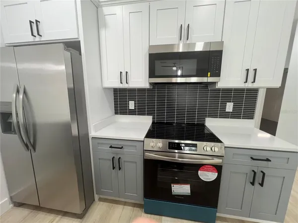 a kitchen with a stove and a refrigerator