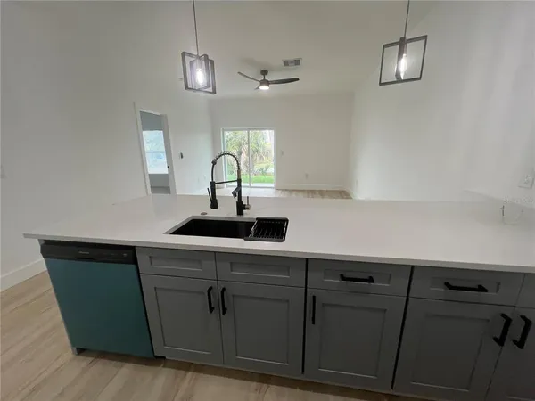a kitchen with a sink and cabinets