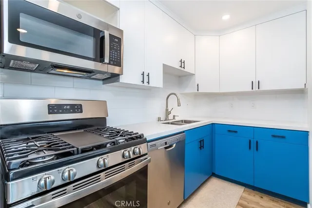 a kitchen with stainless steel appliances granite countertop a stove and a microwave